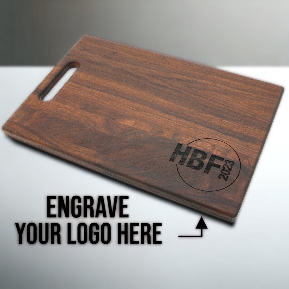Custom logo cutting board in walnut wood with engraved HBF 2023 logo on Tampa Home & Garden Store