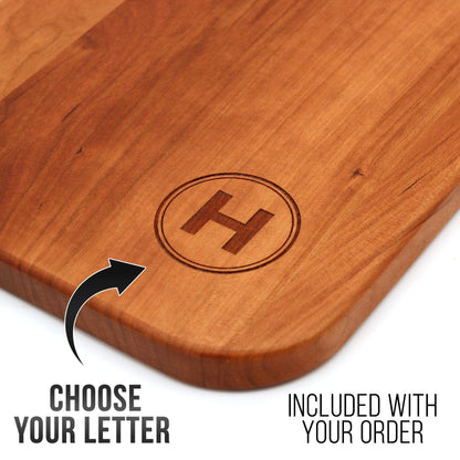 Cherry wood charcuterie board with circular H monogram, personalized last name letter on Tampa Home & Garden Store