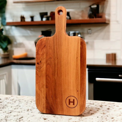 Personalized cherry wood charcuterie paddle board with H monogram on Tampa Home & Garden Store