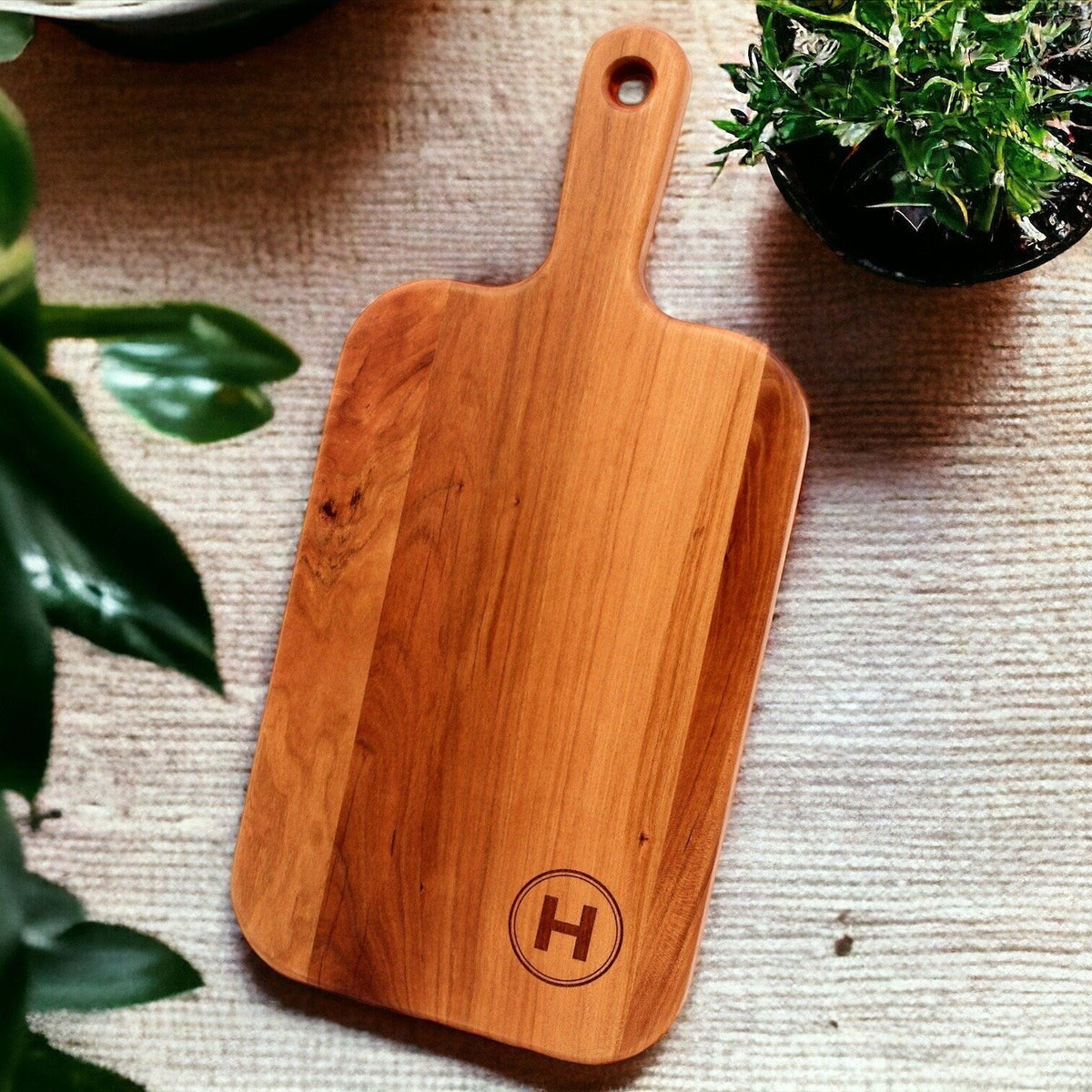 Personalized cherry wood charcuterie board with monogram H, Refine Kitchenware paddle on Tampa Home & Garden Store