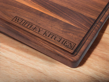 Dark wood cutting board with Whitney Kitchen engraving on Tampa Home & Garden Store
