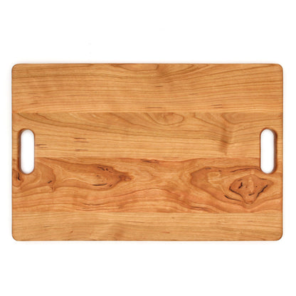 Cherry wood cutting board with rounded corners and dual handle cutouts 18x12 in on Tampa Home & Garden Store