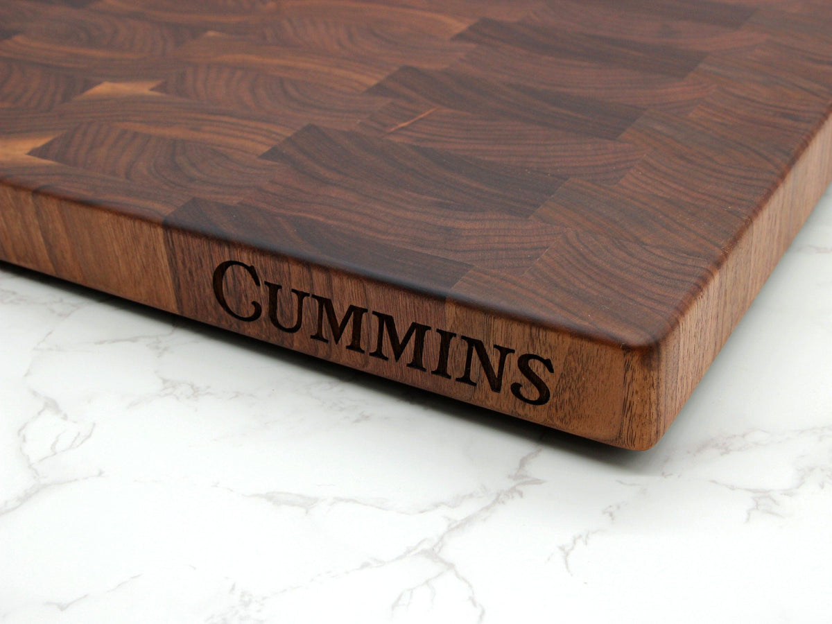 Large end-grain walnut cutting board with edge engraving and rich wood grain pattern on display on Tampa Home & Garden Store