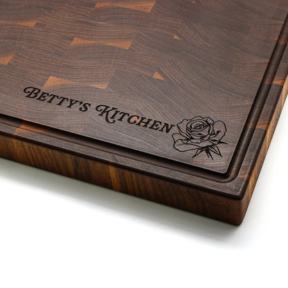 End grain walnut cutting board with maple accents and rubber feet Betty's Kitchen engraving on Tampa Home & Garden Store