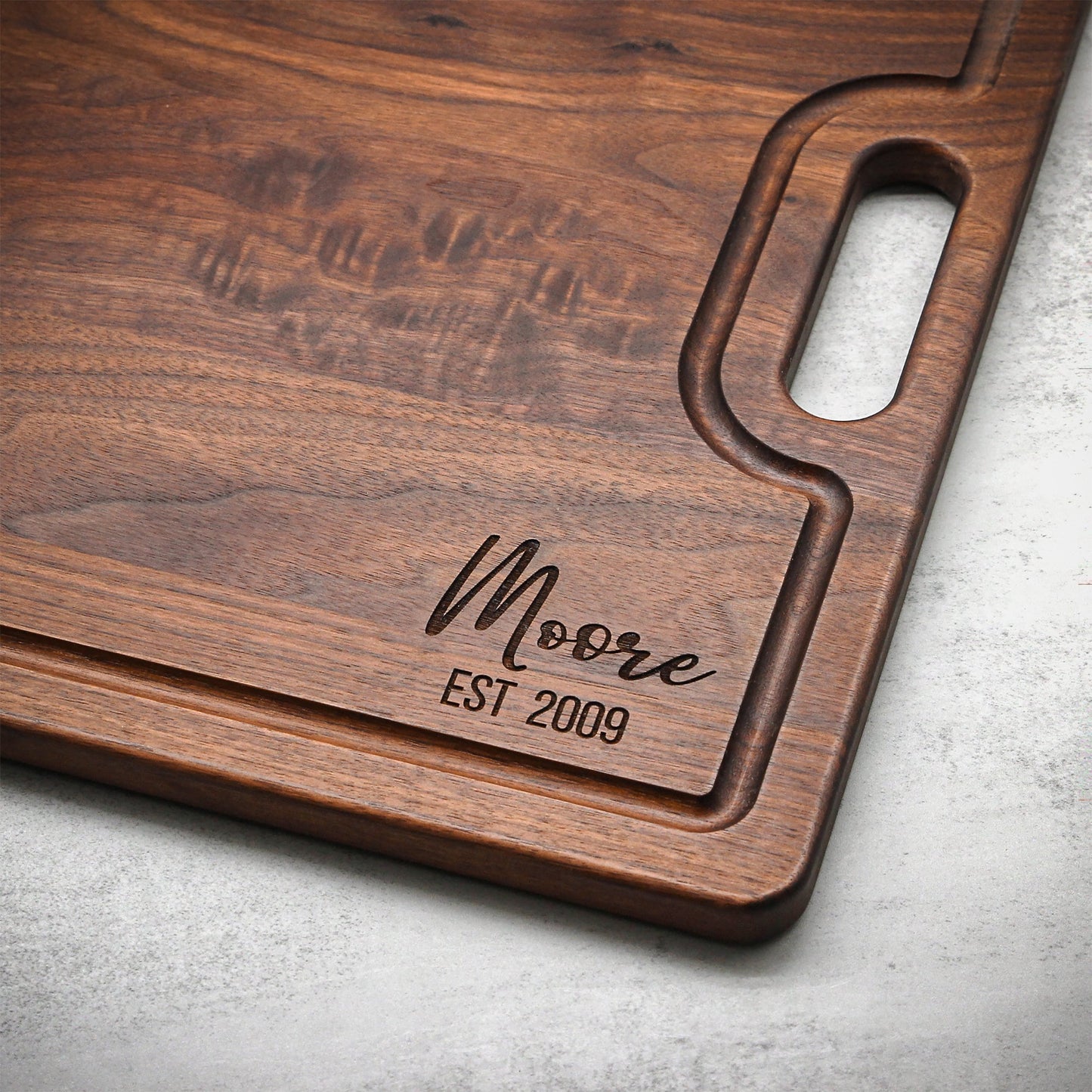 Extra Large Walnut Cutting Board with wide oval handle cutout and rich grain on Tampa Home & Garden Store