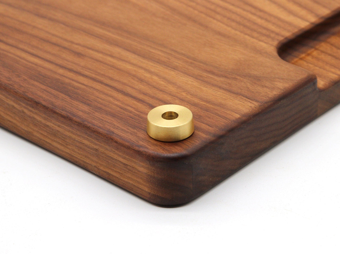 Premium brass cutting board feet with 1-inch diameter brass hardware on a wooden cutting board on Tampa Home & Garden Store