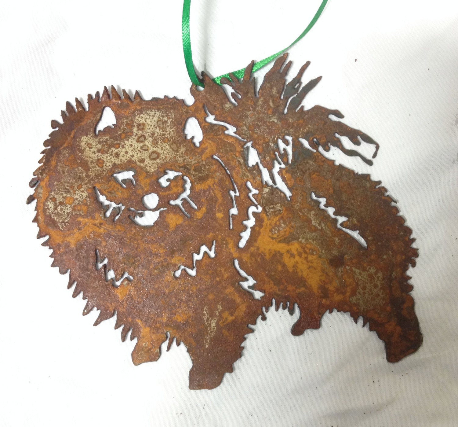 Pomeranian plant stake ornament in rusty metal with green ribbon by Rustica Ornamentals on Tampa Home & Garden Store