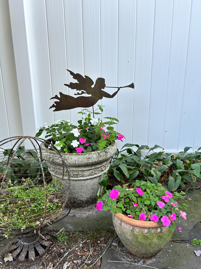 Angel garden stake silhouette in dark metal by Rustica Ornamentals, with planter and flowers on Tampa Home & Garden Store