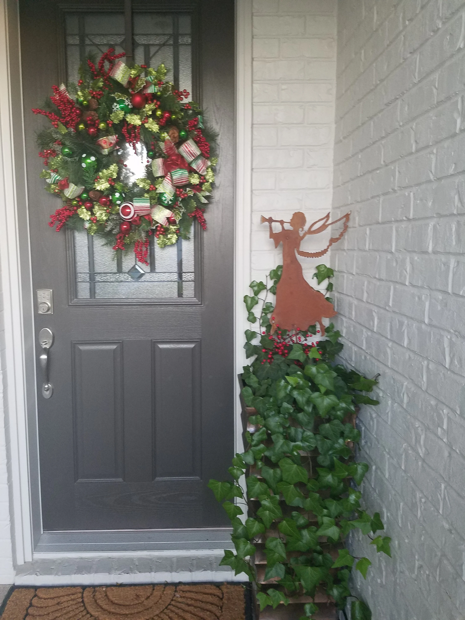 Angel Garden Stake or Wall Art copper by Rustica Ornamentals beside a wreath on door two items on Tampa Home & Garden Store