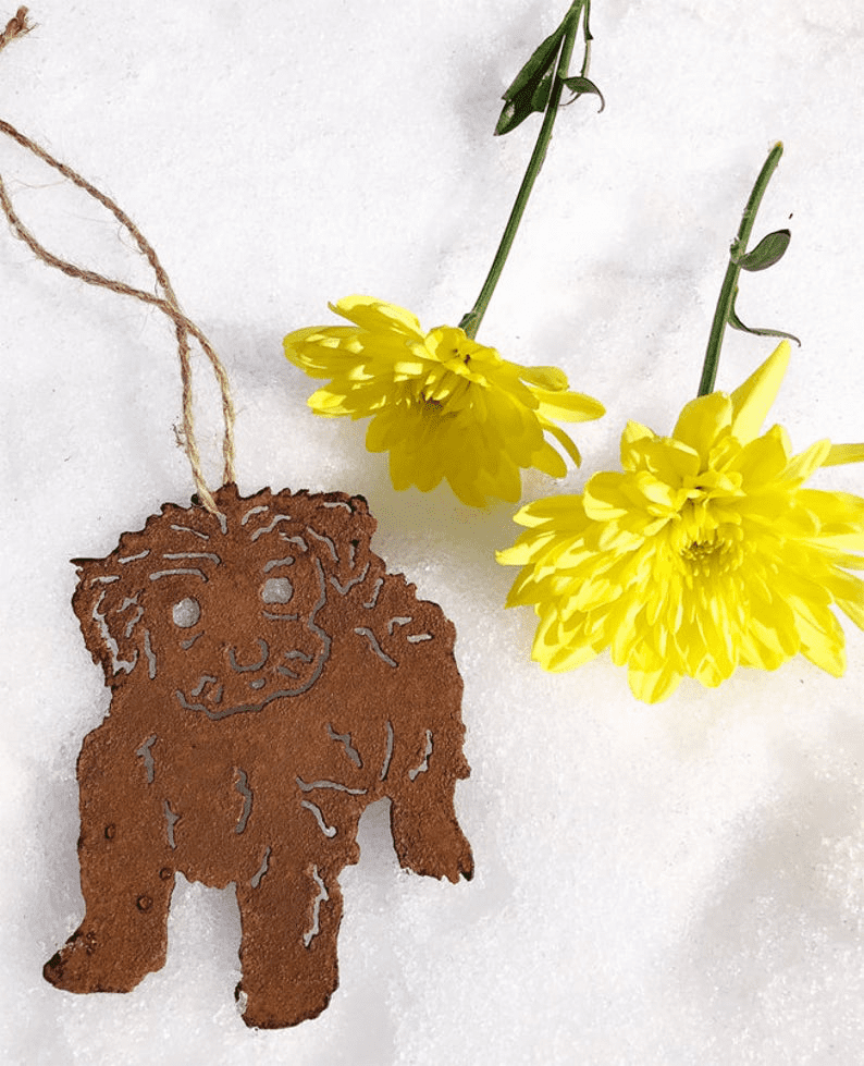 Tea Cup Poodle Plant Stake rusty brown metal silhouette with jute hanger near yellow blooms on Tampa Home & Garden Store