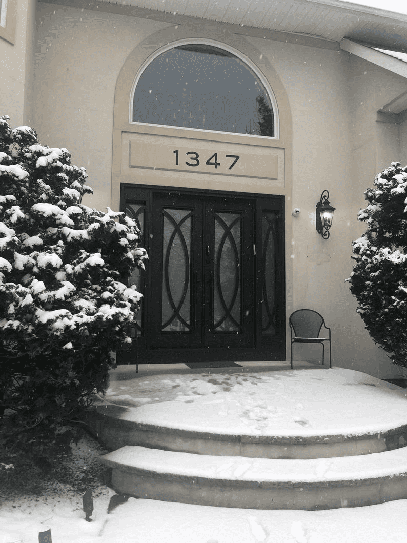 Metal house numbers Blair set of 5 on beige plaque above front door, 1347 in snow scene on Tampa Home & Garden Store