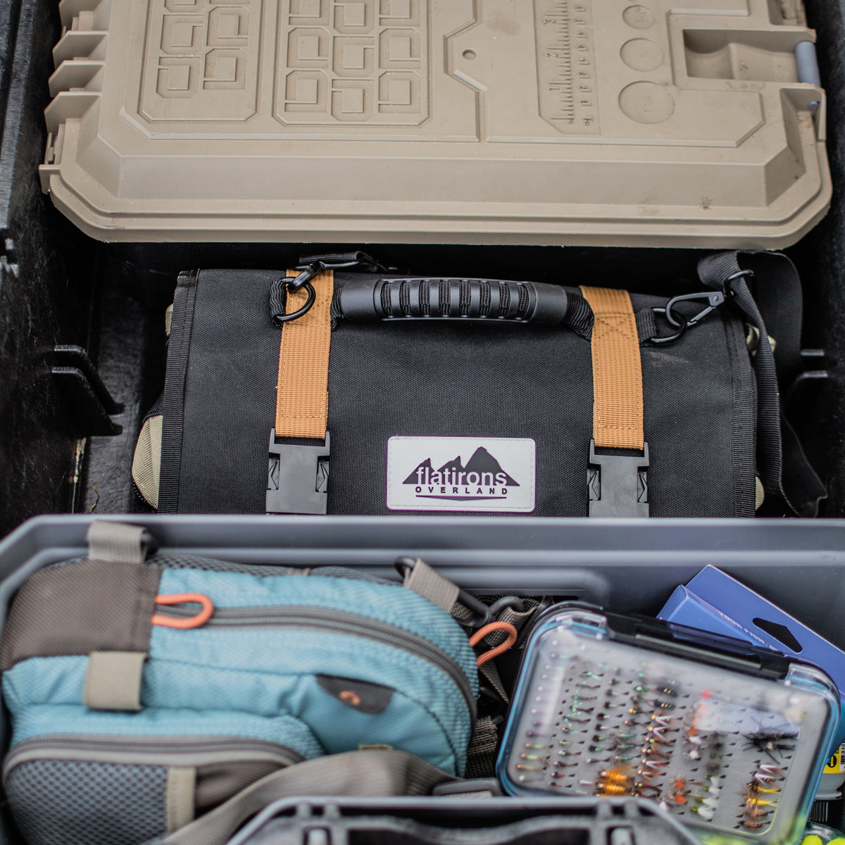 RiPouch Gear Roll by Flatirons Overland; black gear roll with tan straps in vehicle storage on Tampa Home & Garden Store