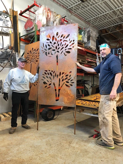 Large pair of outdoor metal privacy screen panels in rusted steel with tree cutouts on Tampa Home & Garden Store