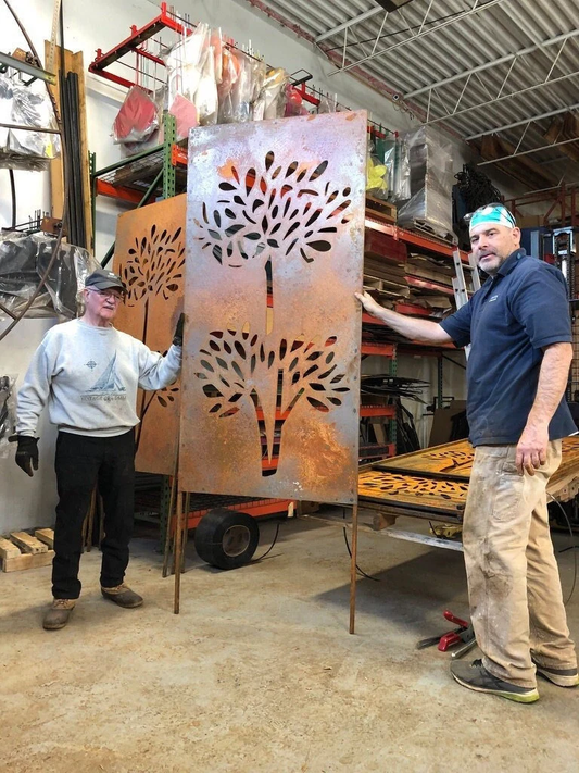 Large pair of outdoor metal privacy screen panels in rusted steel with tree cutouts on Tampa Home & Garden Store