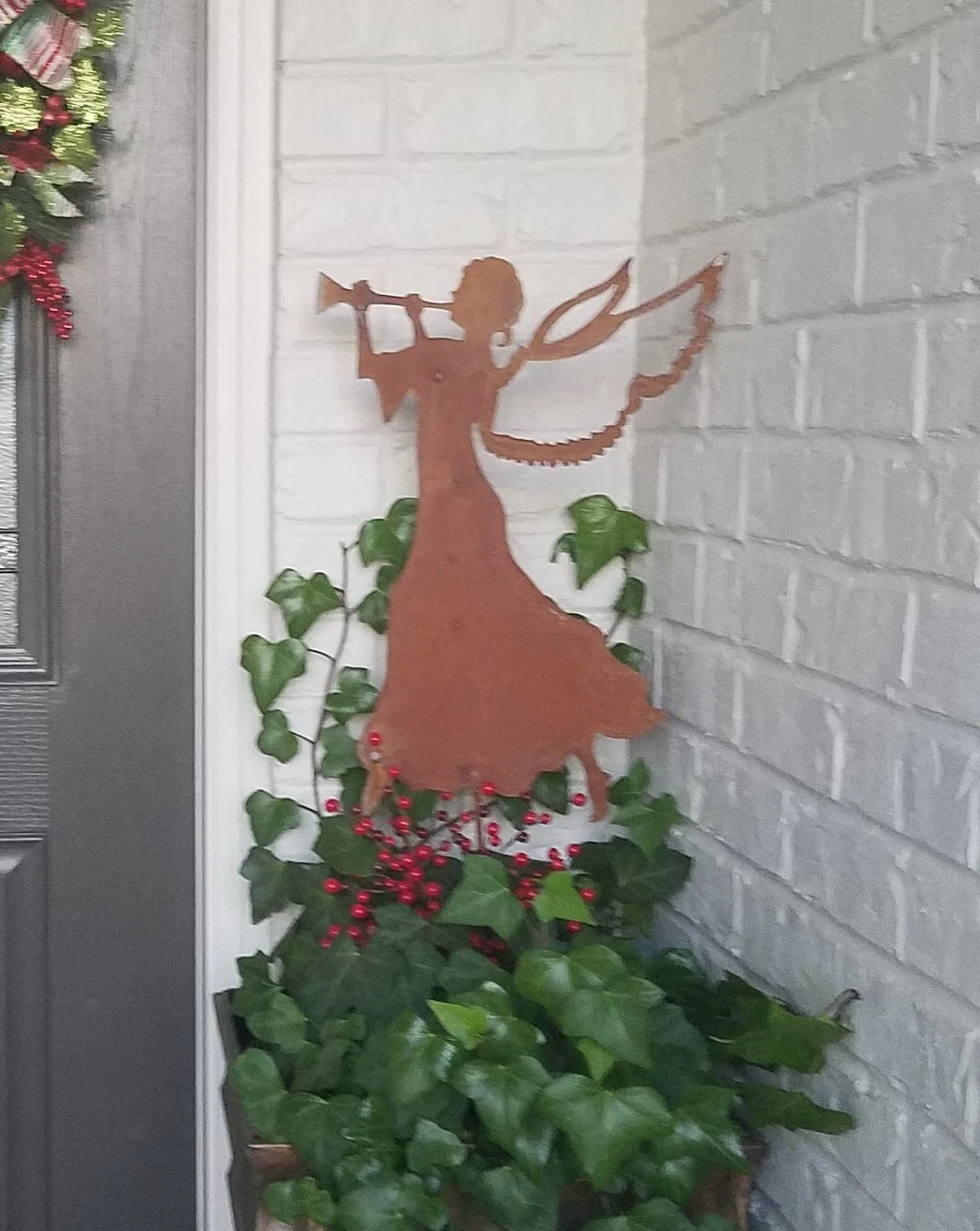 Angel garden stake silhouette in rust metal with trumpet and wings, Christmas decor on Tampa Home & Garden Store
