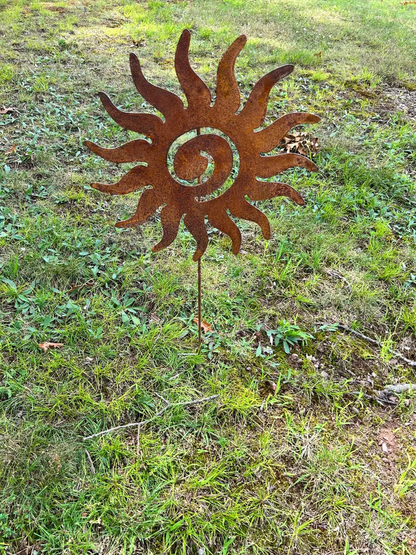 Rusty sun metal art garden stake with spiraled center and curved rays on Tampa Home & Garden Store