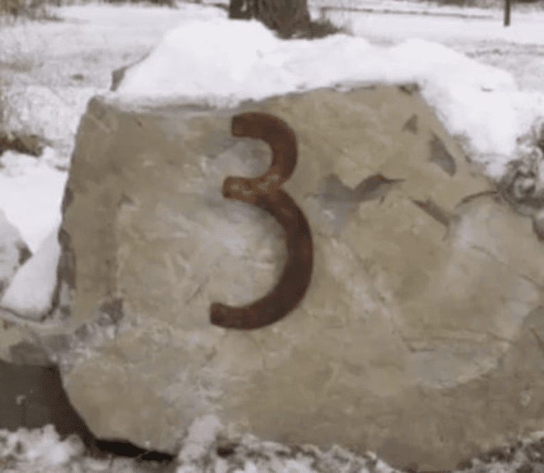 Mission style house number 3 metal numeral in rust on a stone block in snow on Tampa Home & Garden Store