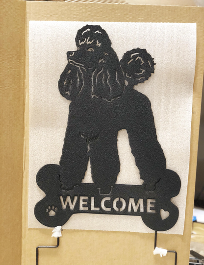 Metal poodle sculpture wall art in black silhouette with a bone-shaped welcome sign on Tampa Home & Garden Store