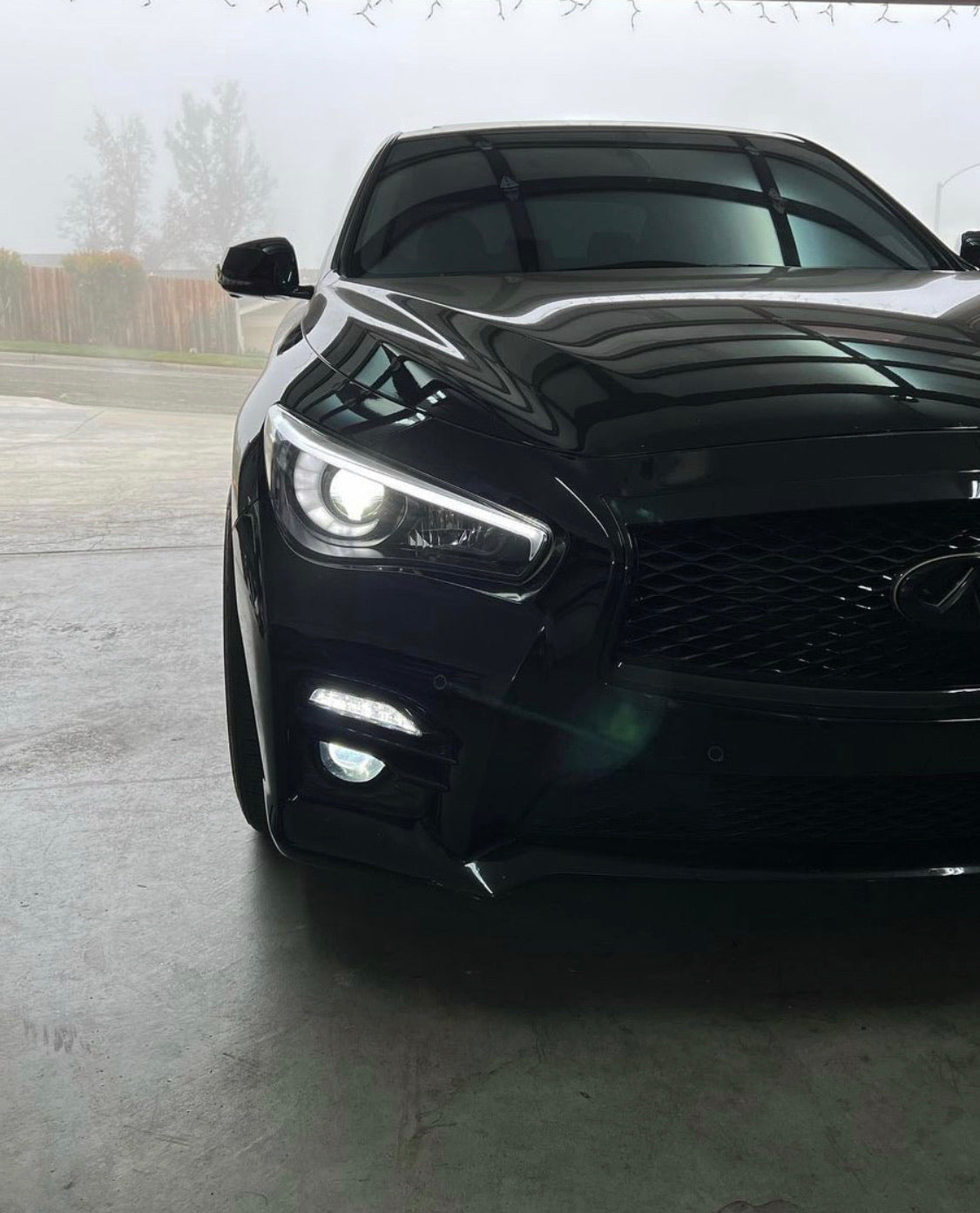 Infiniti Q50 RGBW Flow Series LED DRL boards on black front view with bright LED headlights on Tampa Home & Garden Store