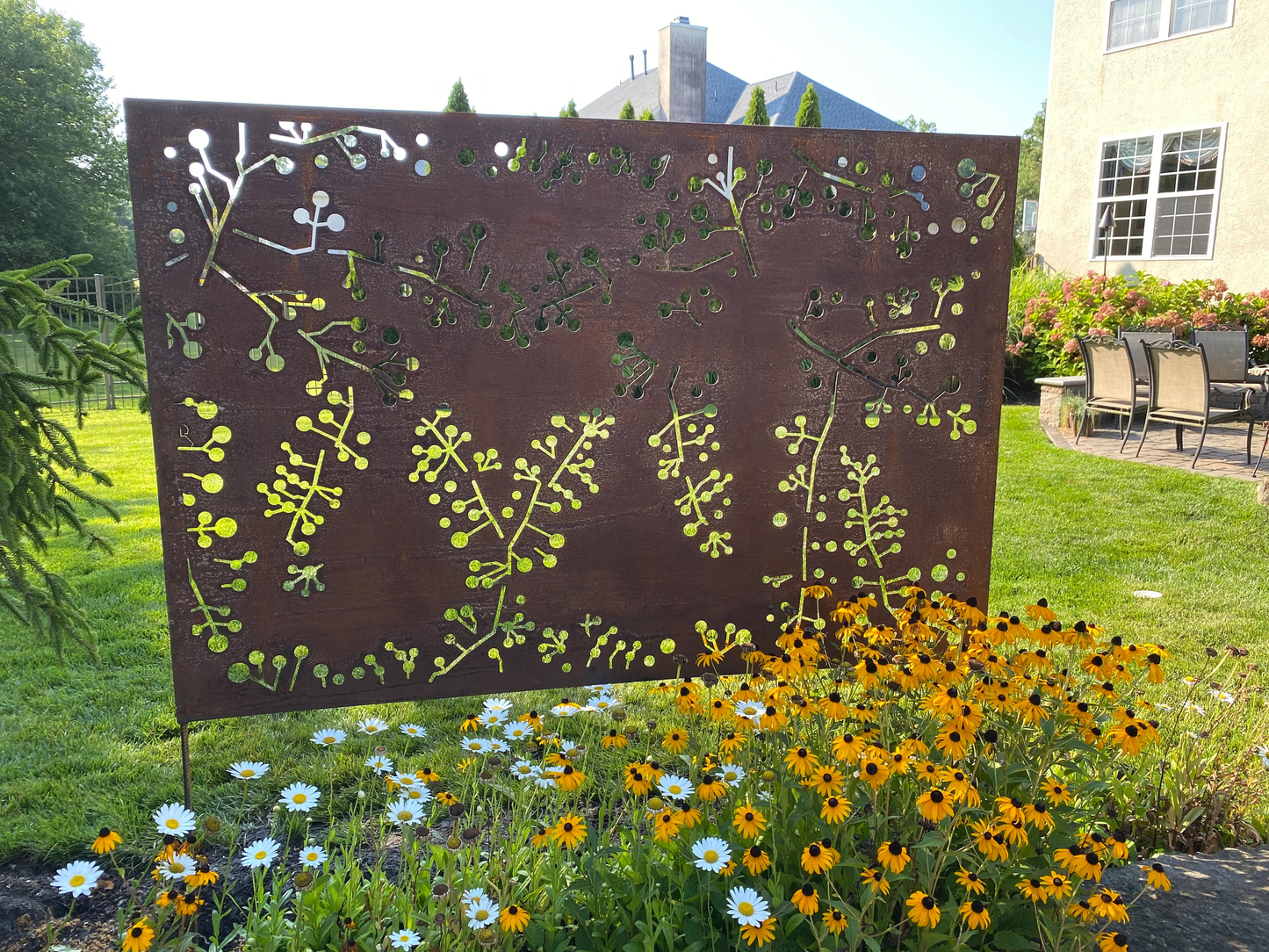 Outdoor metal privacy screen panel with wattle twig cutouts in rust on Tampa Home & Garden Store