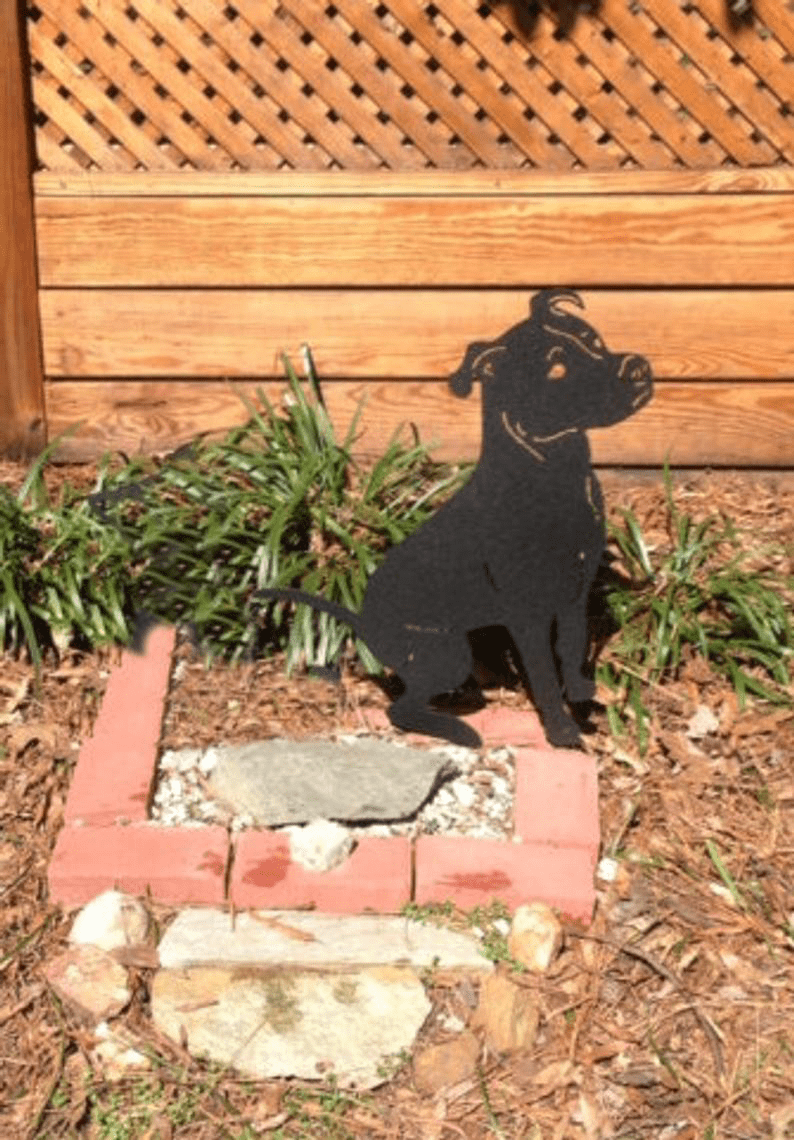 Pit Bull garden statue silhouette, black metal terrier yard sculpture on brick edging on Tampa Home & Garden Store