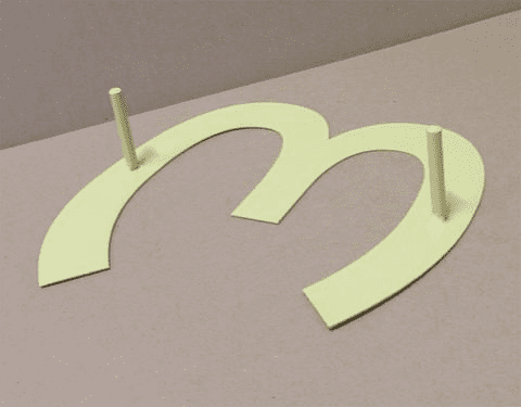 Metal house letters cutout in pale yellow-green with mounting posts for wall display on Tampa Home & Garden Store