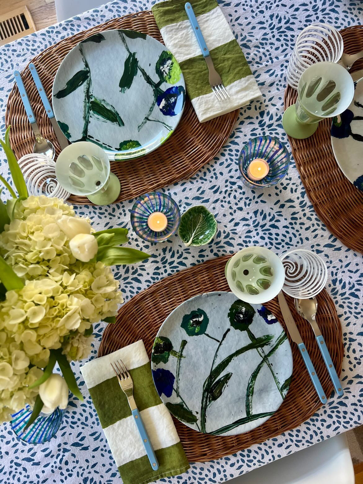 Posey china plates by Erin Donahue Tice, blue teal floral pattern on wicker placemats on Tampa Home & Garden Store