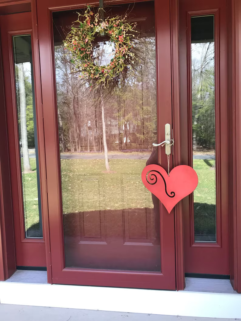 Heart garden stake by Rustica Ornamentals with pink heart and black swirl on red front door on Tampa Home & Garden Store