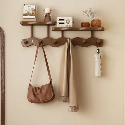 Bamboo wall coat rack with two shelves and five hooks, tan handbag, beige scarf, and umbrella on Tampa Home & Garden Store