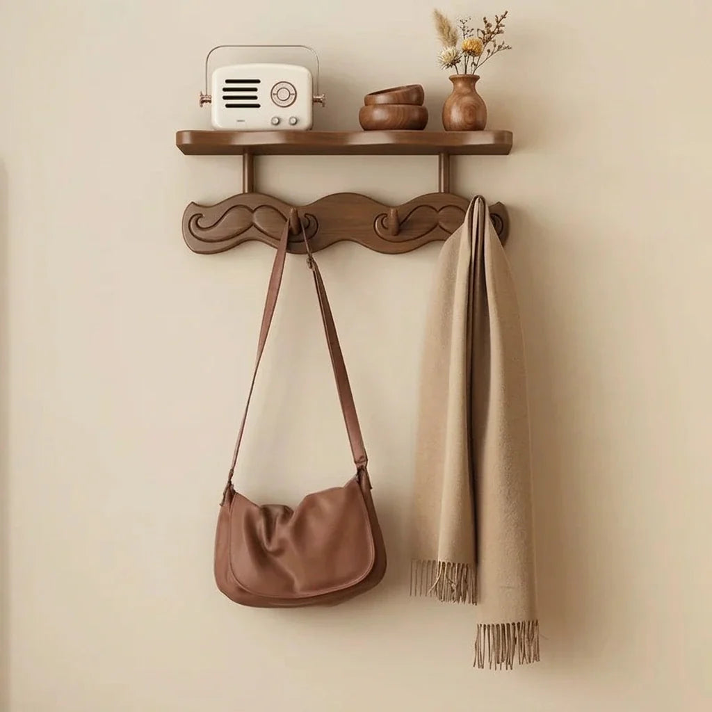Bamboo wall coat rack with shelf and carved hooks, beige scarf and brown handbag hanging on Tampa Home & Garden Store
