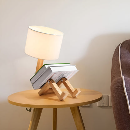 Moktan Sabai bamboo table lamp with natural wooden tripod base and ivory shade, 3-book stack on round table on Tampa Home & Garden Store