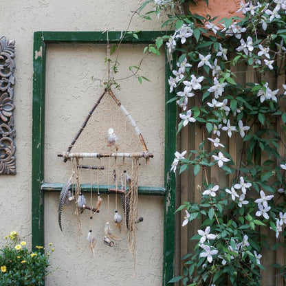 Indiana Dream Catcher Net by RusticReach with beige twine and hanging feathers in a garden frame on Tampa Home & Garden Store