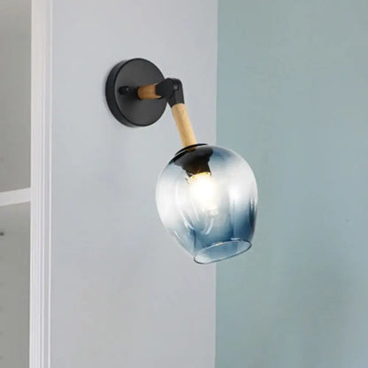 Blue glass wall sconce with wooden arm and black round wall mount by Decorbites on Tampa Home & Garden Store