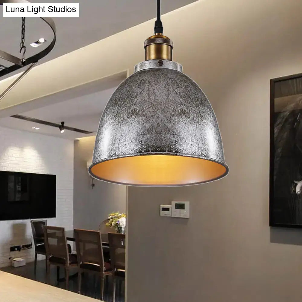 Black dome pendant lamp by Decorbites with distressed metal shade and brass top, amber glow on Tampa Home & Garden Store