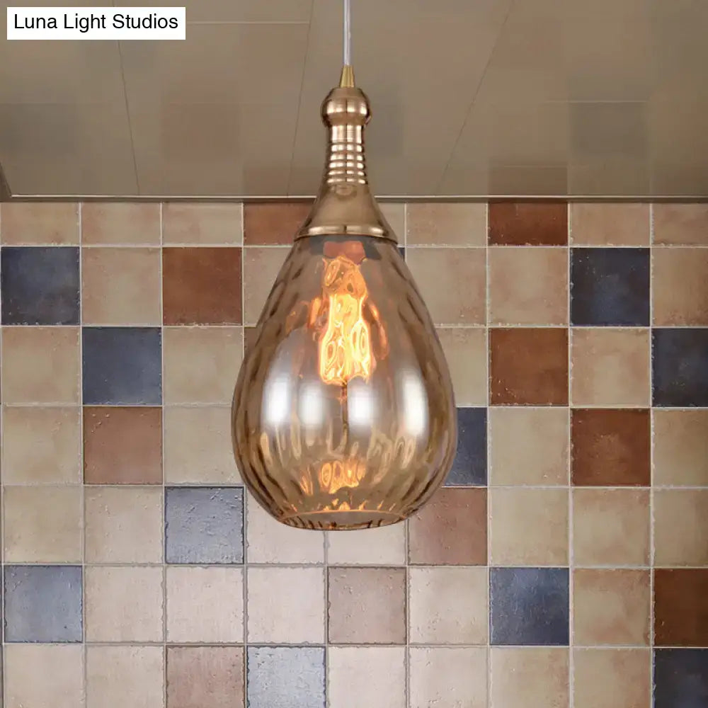 Smoked glass teardrop pendant light with amber glow and brass hardware Decorbites on Tampa Home & Garden Store