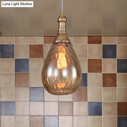Smoked glass teardrop pendant light with amber glow and brass hardware Decorbites on Tampa Home & Garden Store