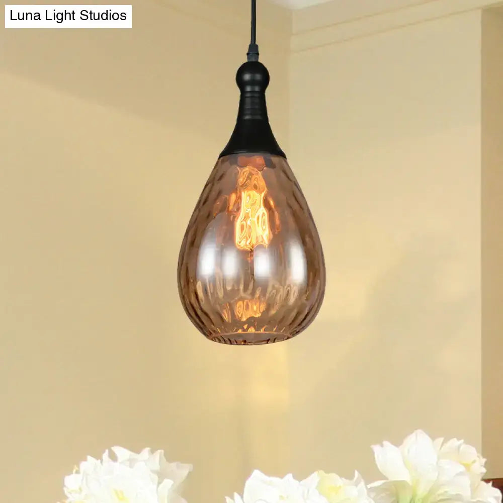 Smoked glass teardrop pendant light by Decorbites; black canopy and warm Edison glow on Tampa Home & Garden Store