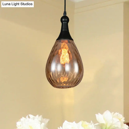 Smoked glass teardrop pendant light by Decorbites; black canopy and warm Edison glow on Tampa Home & Garden Store