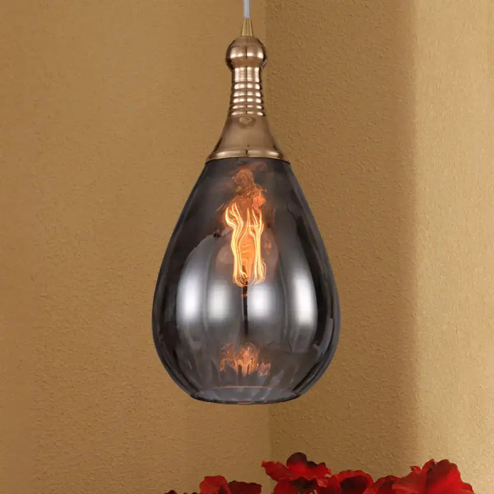 Smoked glass teardrop pendant light with brass hardware and vintage filament bulb on Tampa Home & Garden Store