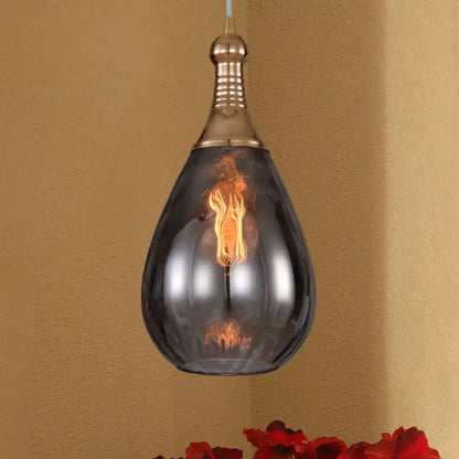 Smoked glass teardrop pendant light with brass hardware and vintage filament bulb on Tampa Home & Garden Store