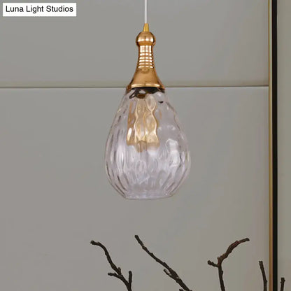 Smoked glass pendant light with brass cap, teardrop-shaped clear glass by Decorbites on Tampa Home & Garden Store