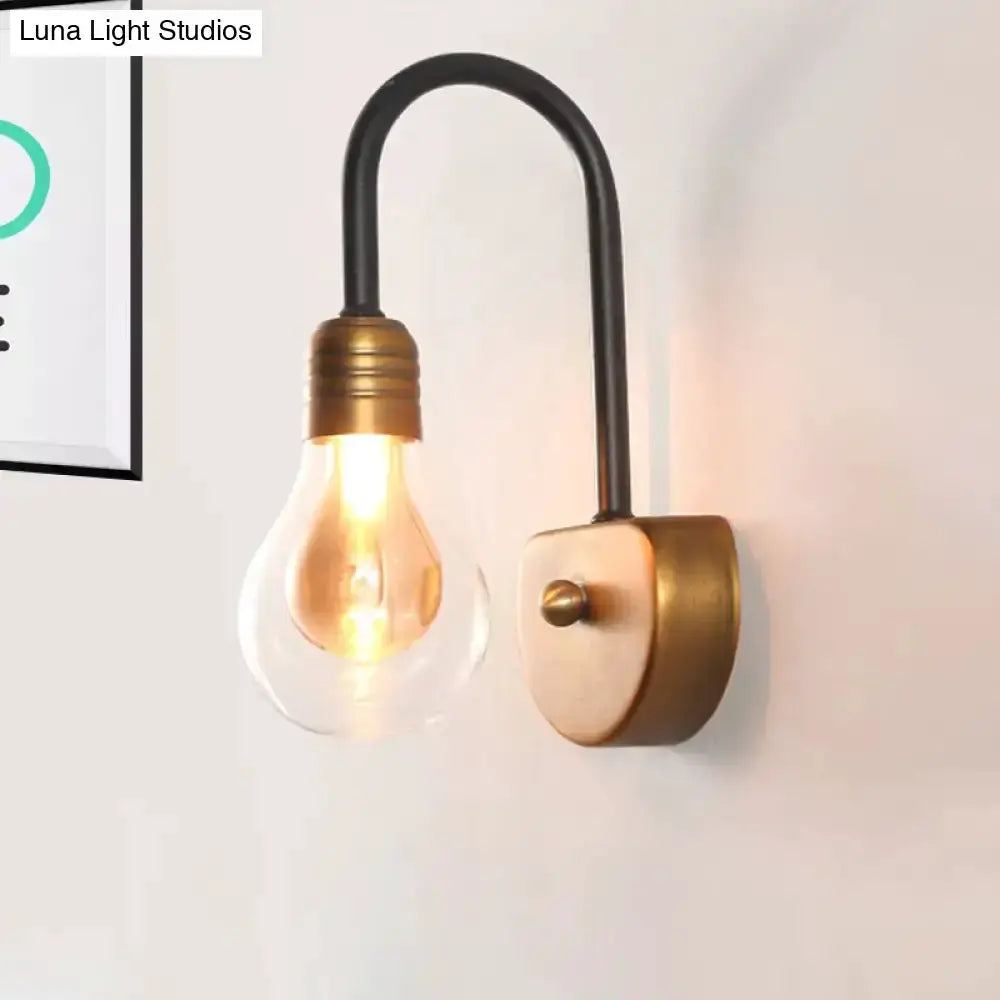 Industrial black and brass wall lamp with curved arm and Edison bulb bedroom light fixture on Tampa Home & Garden Store