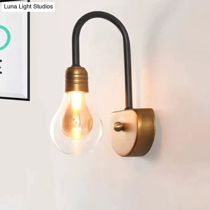 Industrial black and brass wall lamp with curved arm and Edison bulb bedroom light fixture on Tampa Home & Garden Store