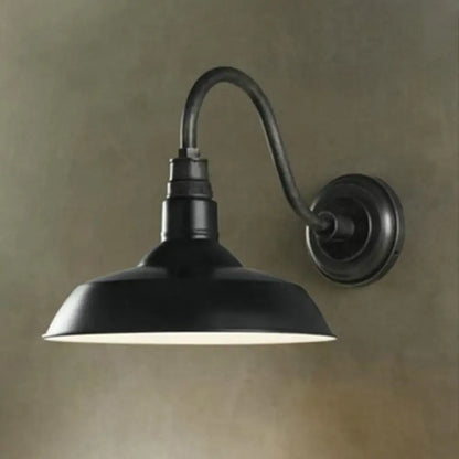Black metal shade wall sconce by Decorbites with curved arm wall mount on Tampa Home & Garden Store