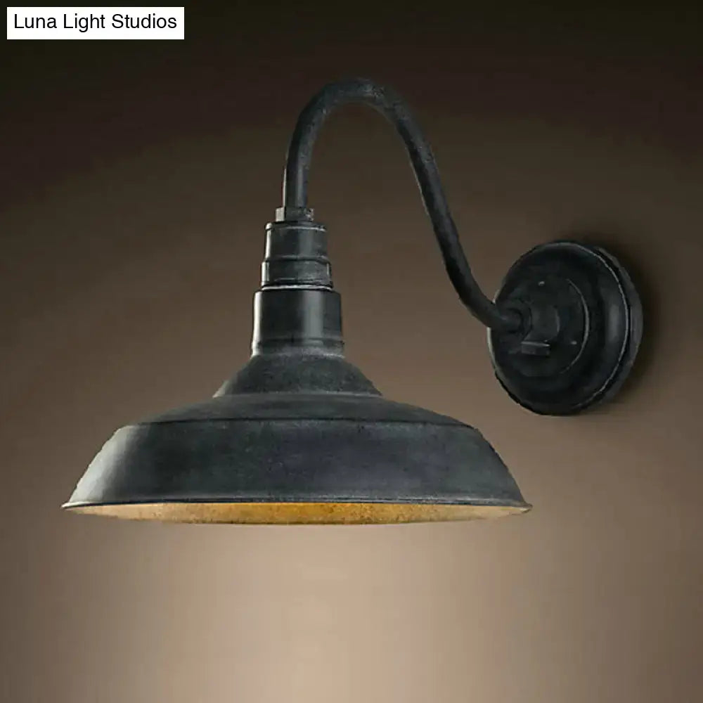 Decorbites black metal shade wall sconce with curved arm and backplate on Tampa Home & Garden Store