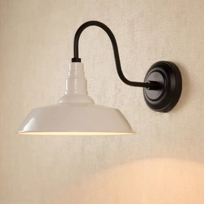 Black metal shade wall sconce by Decorbites with curved arm and white shade on Tampa Home & Garden Store