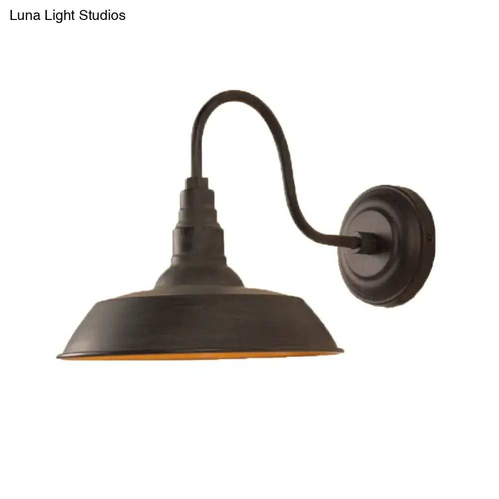 Black metal wall sconce with curved arm and wide downward shade, Decorbites on Tampa Home & Garden Store