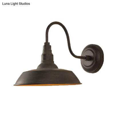 Black metal wall sconce with curved arm and wide downward shade, Decorbites on Tampa Home & Garden Store