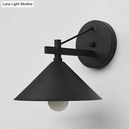 Black metal cone wall sconce by Decorbites; wall mount with round backplate and angled arm on Tampa Home & Garden Store