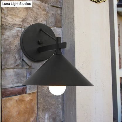 Black metal cone wall sconce by Decorbites with round backplate and exposed bulb on Tampa Home & Garden Store